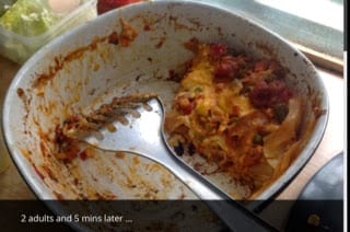 Scooping out lasagna with a stainless steel spatula